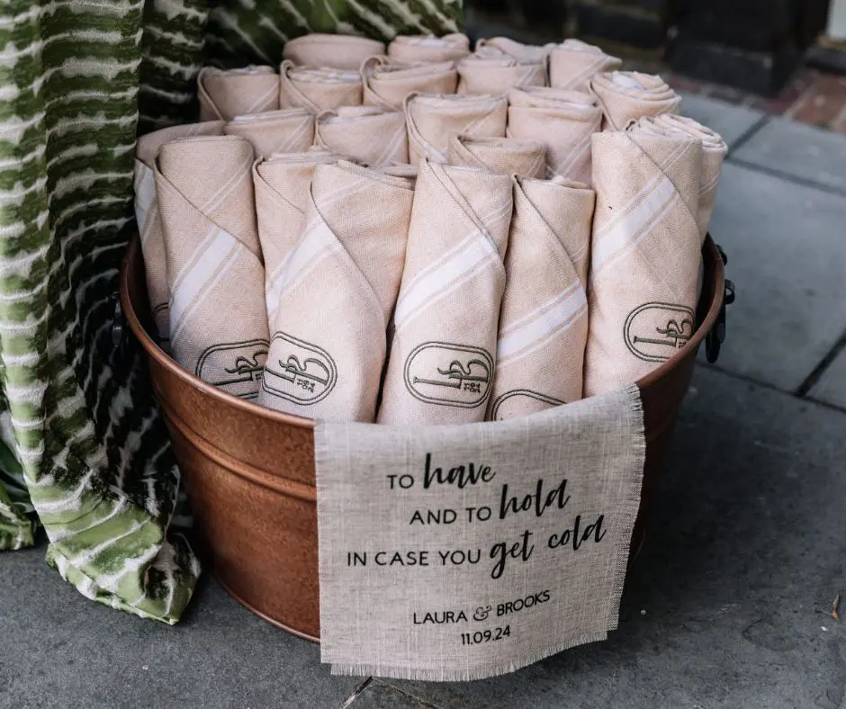 Wedding Favors by Brittney Raines Bucket filled with beige blankets for wedding favor