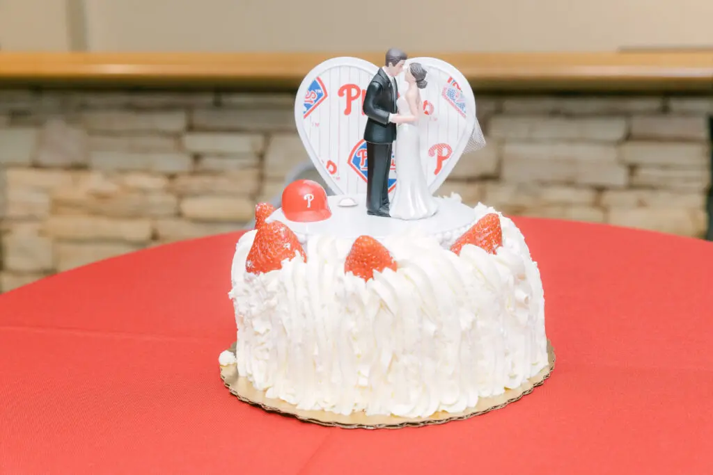 Phillies Cake by Mario Top Photography Phillies themed cake with bride and groom topper