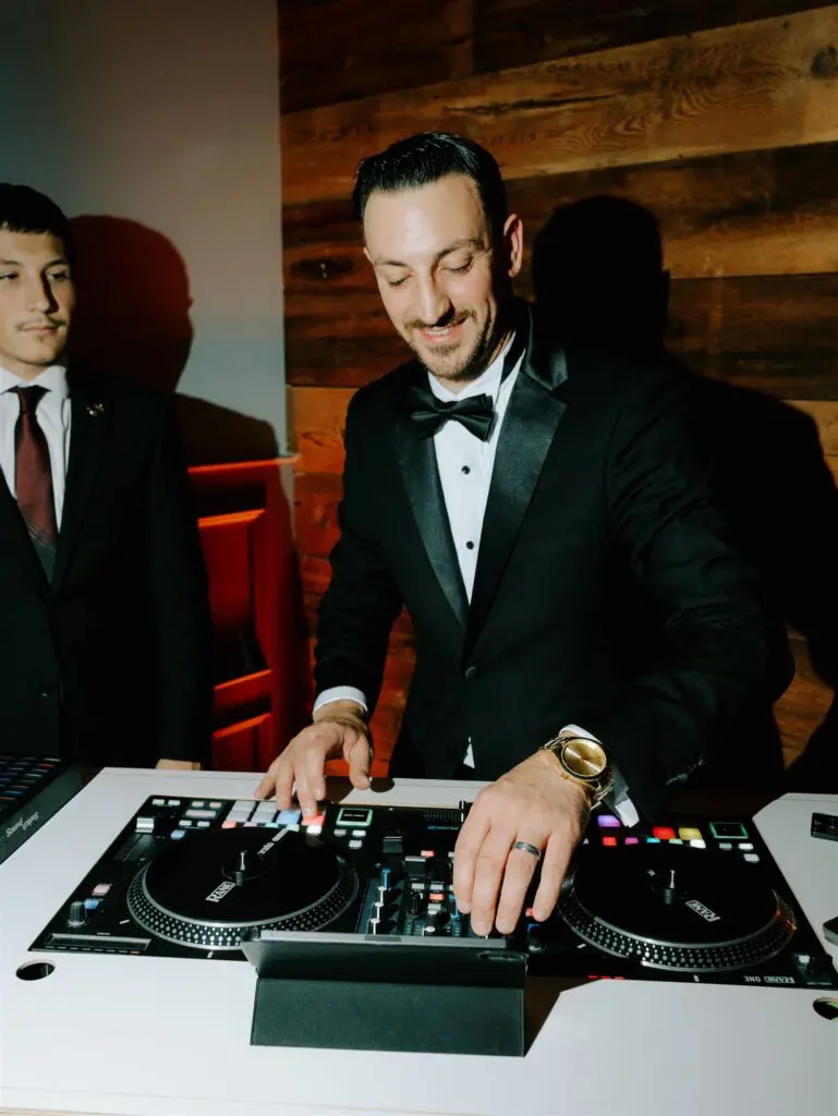 Philadelphia wedding DJ, DJ Pat ryan, mixing at a wedding with a big smile
