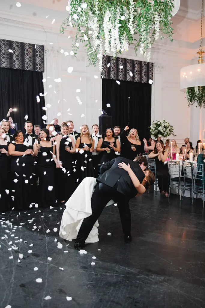 MH 4-27-24 Slosman-Funkey @ Downtown Club by Asya Photography (30) Bride and Groom first dance kiss showered in white rose petals