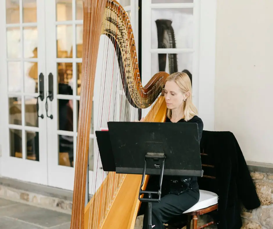 Specialty Musician by Emily Wren Harpist sitting down playing at a wedding ceremony
