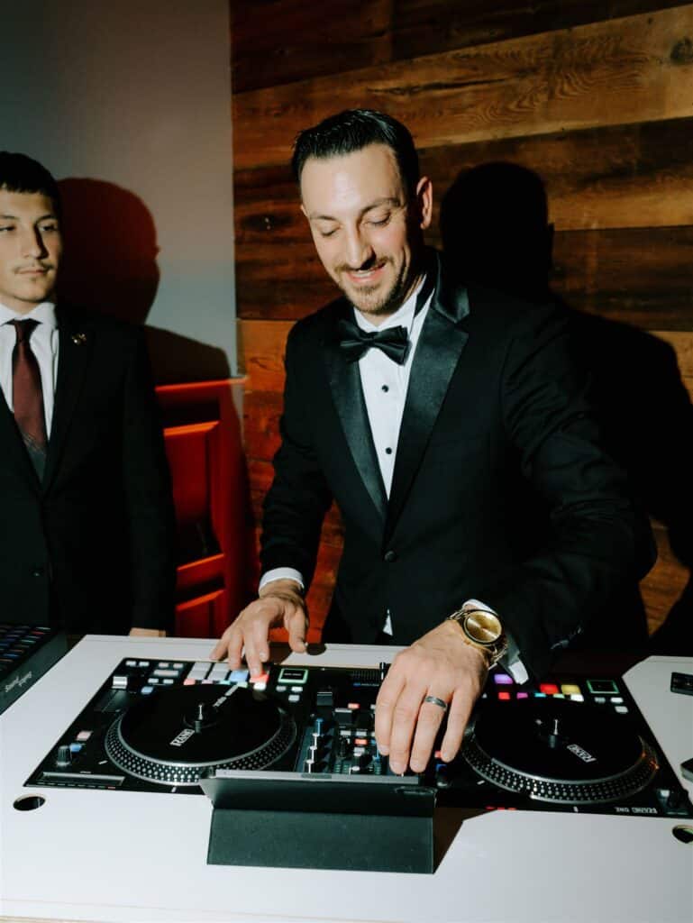 Philadelphia wedding DJ, DJ Pat ryan, mixing at a wedding with a big smile
