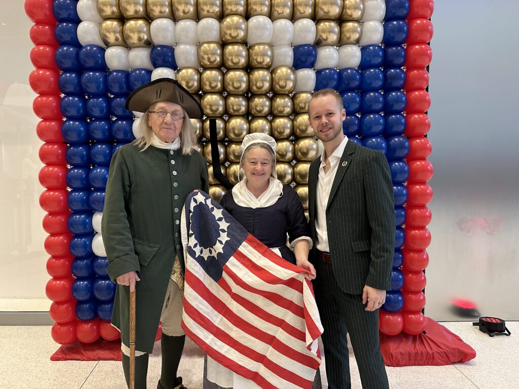 Betsy Ross Impersonator alongside Benjamin Franklin poses with Nils Mossblad at the Comcast Center