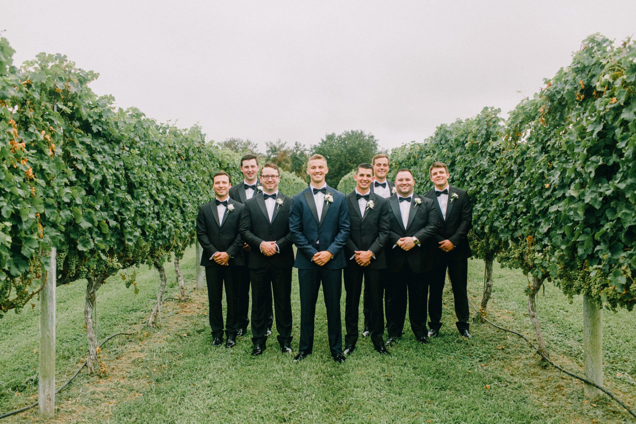 Groomsmen in apple orchard