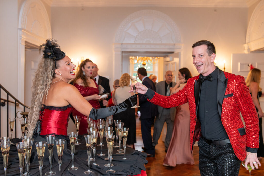 Strolling Table Performer Handing out Champagne by Bark Studio